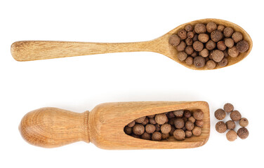 Allspices or Jamaica pepper in wooden spoon isolated on white background. Top view