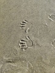 Fototapeta na wymiar handprints in sand