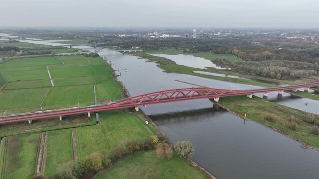 The Hanzeboog railway bridge near Zwolle over the river IJssel part of the railway line Utrecht Kampen and the railway line Lelystad Zwolle. Aerial drone overview.