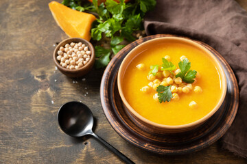 Comfort food, fall and winter healthy slow food concept. Vegetarian pumpkin and chickpea cream soup...