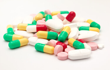 Multicolored pills on a white background. Red, yellow,white, green medicines. Antibiotics
