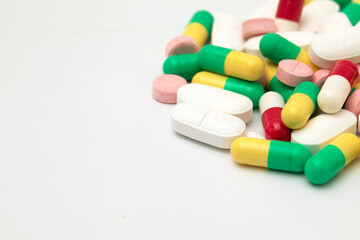 Multicolored pills on a white background. Red, yellow,white, green medicines. Antibiotics