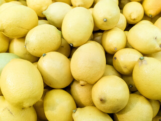 Ripe Yellow Lemons Close-Up Background Or Texture. Harvest Lemons, Lots of Yellow Lemons. Vitamin C.