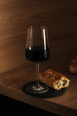 A glass of wine with bread in minimalistic style	