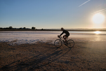 Fototapeta na wymiar Man riding on gravel bike. Cyclist practicing on gravel roads. Sport motivation. Cycling life