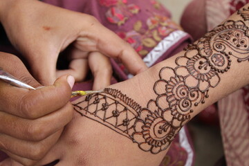 Image of hand painted on henna mehendi tattoo. Indian Mehendi celebration. Henna application and...