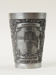 Traditional German vintage pewter wine glass with a bas-relief depicting a pulpit in an abbey church built in 1504 in the city of Herrenberg - 556173716