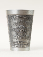 Traditional German vintage pewter wine glass with a bas-relief depicting the Coat of arms of the districts of the city of Herrenberg - 556173958