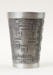 Traditional German vintage pewter wine glass with a bas-relief depicting the Coat of arms of the districts of the city of Herrenberg - 556173969