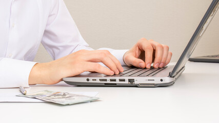 Image of male hands typing on a laptop. close-up. selective focus