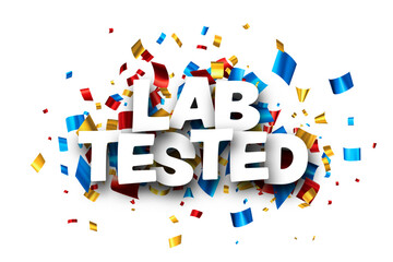 Lab tested sign with colorful cut out foil ribbon confetti background.