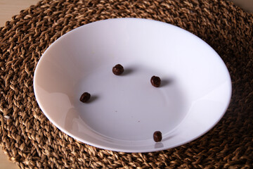 photo of several cereal balls lying on a white container