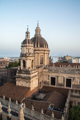 Naklejka na ściany i meble View at Catania Cathedral and Ionian sea from the dome of the Abbey of St Agatha at sunset, Sicily, Italy