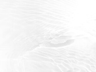 Obraz premium Defocus blurred transparent white colored clear calm water surface texture with splashes and bubbles. Trendy abstract nature background. Water waves in sunlight with copy space. White water shine
