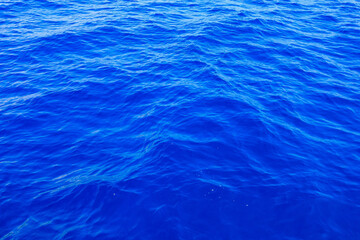 Very nice sea water background or backdrop with selective focus. Small waves of natural water surface texture.