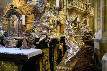 Candlesticks with religious sculptures. Gothic Catholic Cathedral of St. Vitus, Wenceslas and Vojtech in Prague Castle