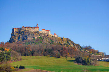 The medieval Riegersburg Castle on top of a dormant volcano, surrounded by beautiful autumn...