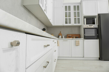 Fototapeta na wymiar Beautiful kitchen interior with stylish modern furniture