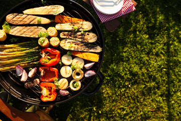 Delicious grilled vegetables on barbecue grill outdoors, top view. Space for text