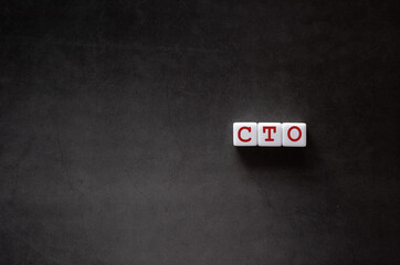 There is white cube with the word CTO. It is an abbreviation for Chief Technology Officer as...