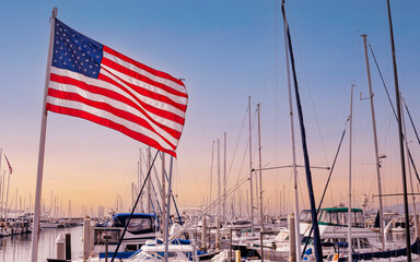 Santa Barbara harbor with an American flag under sunset - obrazy, fototapety, plakaty