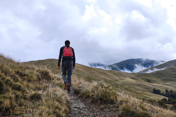 Fototapeta premium a man walks through picturesque mountains mountain landscape