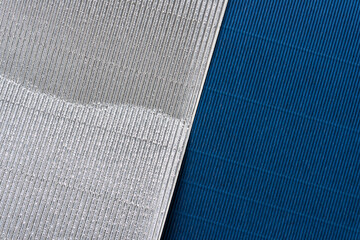 creased silver and dark blue corrugated paper background