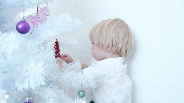 Portrait of a little boy decorating a Christmas tree