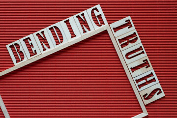 bending truths and wood frame on red corrugated paper