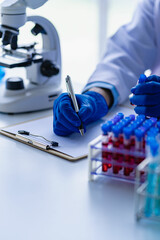 Professional doctor examining arterial blood sample, professional research in nurse with microscope...