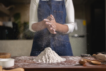 Chef mix the flour by to hand make bread according formula