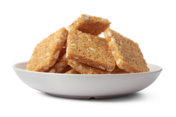 coconut biscuits, textured crispy square shaped homemade cookies on a white plate isolated