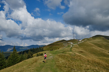 Obraz premium The man stands on the edge of a high mountain . The man looks at the beautiful mountain landscape