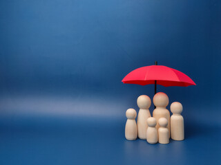 A family of wooden dolls are hiding under a red umbrella, protecting wooden peg dolls, planning,...