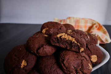 Chocolate cookies with peanut butter on a dark background