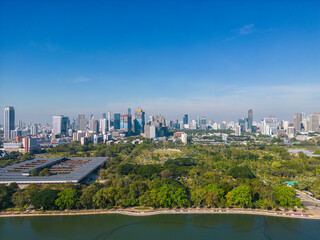 Obraz na płótnie Canvas Benjakitti Forest public Park new landmark of central Bangkok with office building aerial view