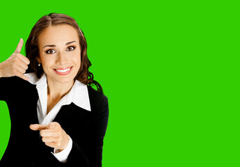 Businesswoman in black confident suit showing call me hand sign gesture and pointing at viewer....