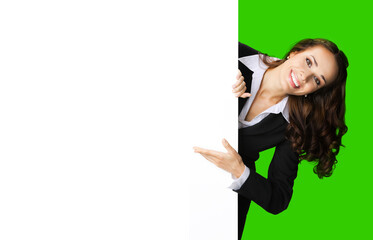 Happy excited smiling woman in black confident suit showing white banner signboard. Business and advertising concept. Copy space empty place. Green chroma key background.