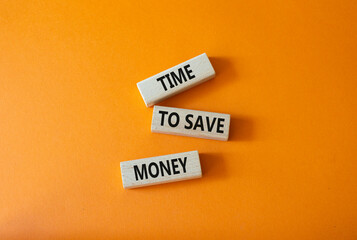 Time to save money symbol. Wooden blocks with words Time to save money. Beautiful orange background. Business and Time to save money concept. Copy space.