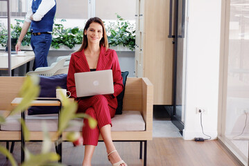 beautiful business woman smiling sitting at work using laptop.