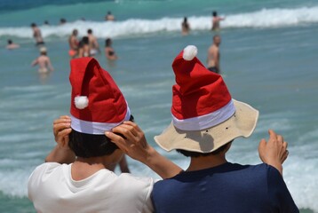Two santa hats at Bondi Beach on Christmas Day
