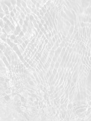 Defocus blurred transparent white colored clear calm water surface texture with splashes and bubbles. Trendy abstract nature background. Water waves in sunlight with copy space. White water shine