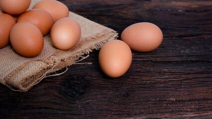 fresh organic chicken eggs. on sack and brown wooden board,