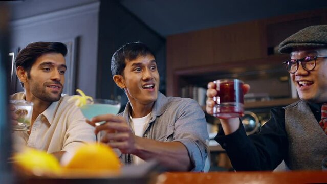 Group of Man friends celebrating holiday event dinner party drinking cocktail and whiskey together at luxury restaurant bar. Happy guy enjoy and fun hangout meeting nightlife at nightclub on vacation