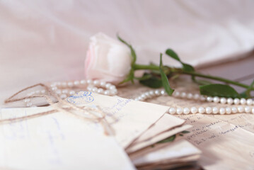 White rose and letter on the table. Top view. Letter of the love