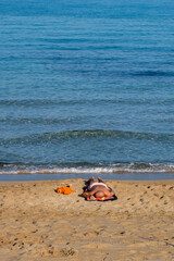 Fototapeta na wymiar Caucasian man sleeping and relaxing on the shore. Summer holidays at beach