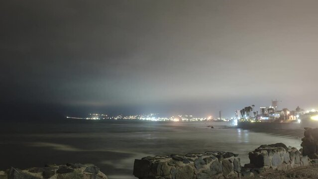 Timelapse of clouds rolling in over Ensenada, Mexico with fireworks.