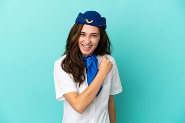 Naklejka premium Airplane stewardess woman isolated on blue background celebrating a victory