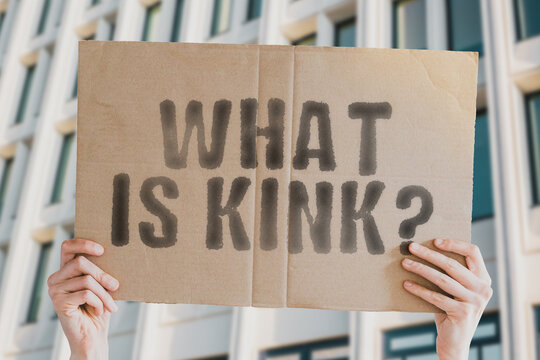 The question " What is Kink? " is on a banner in men's hands with blurred background. Love. Pleasure. Set. Accessory. Sadomasochism. Equipment. Woman. Playful. Blindfold. Pain. Rope. Desire. Wild