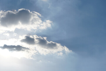 Blue sky with fluffy white clouds constantly changing shape.